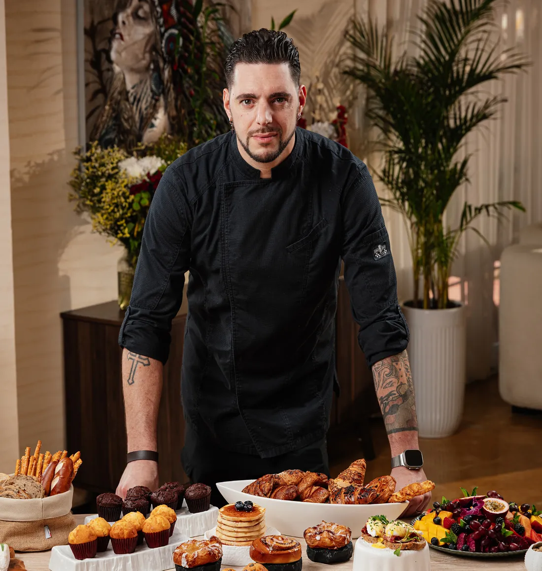 Chef Luca Napoleone standing behind a breakfast service he has prepared